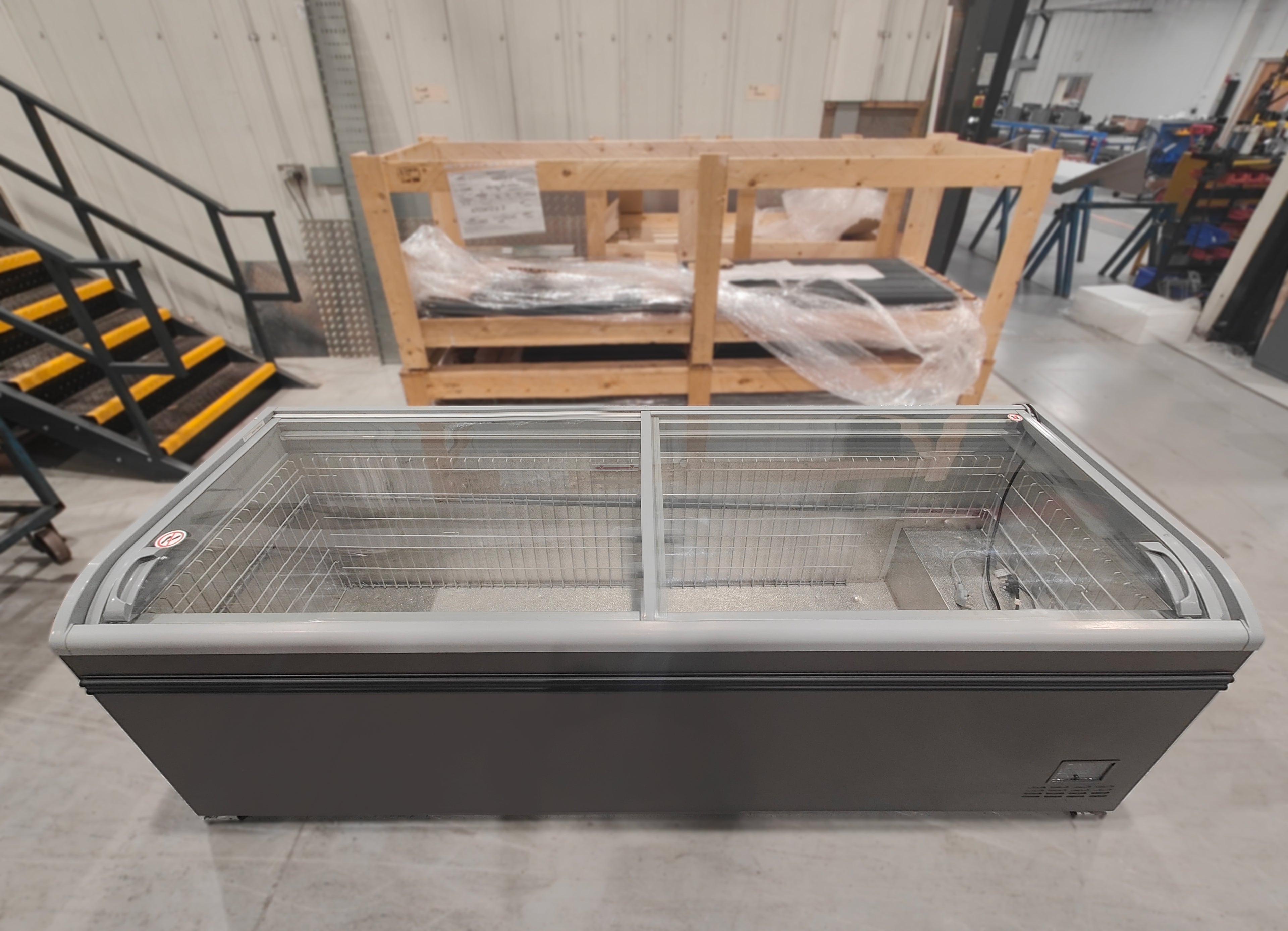 AHT Athens chest freezer — top view showing curved glass sliding lids open with wire baskets